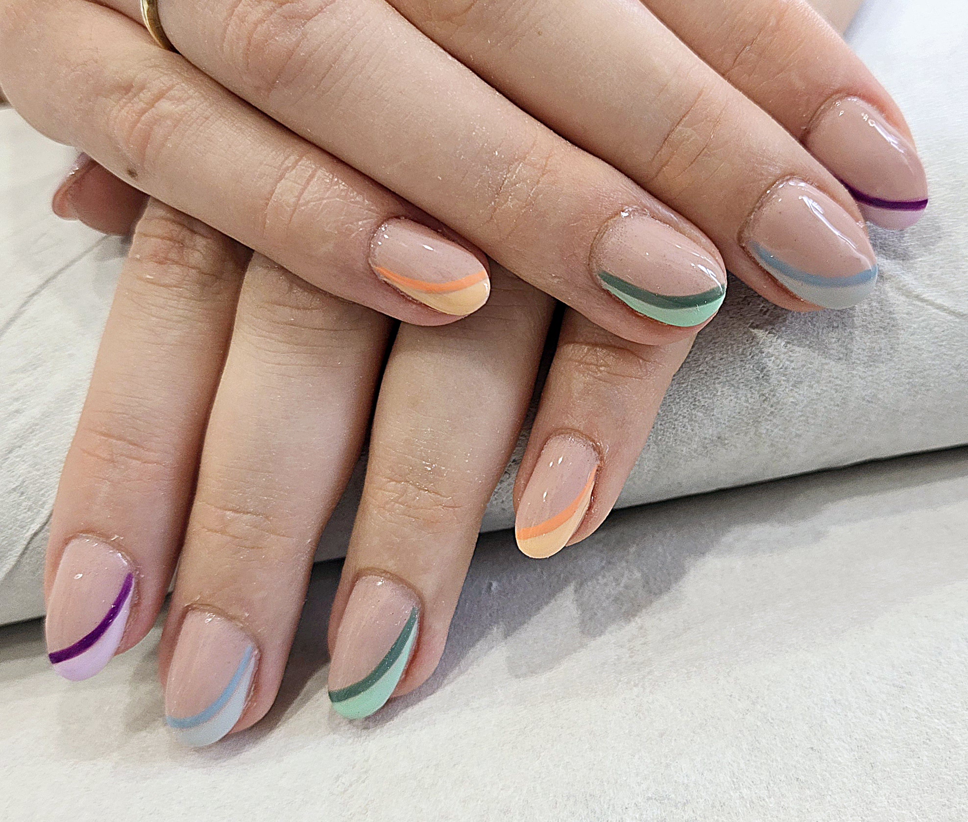 Nude nails with pastel swirl tips