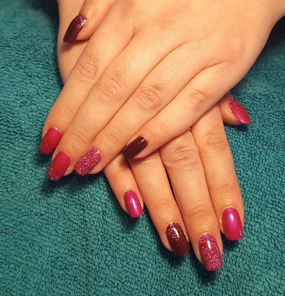 Berry red nails with a glitter accent